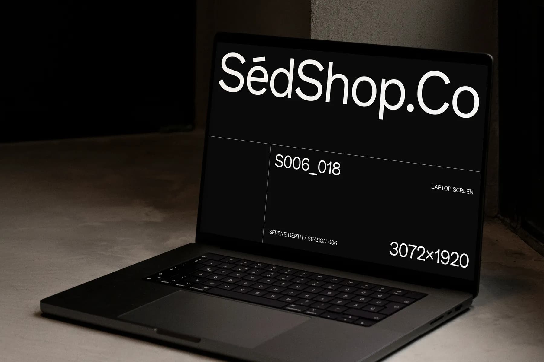 Close-up mockup of an open laptop screen displaying SédShop.Co design in a dark theme with a minimalist interface.
