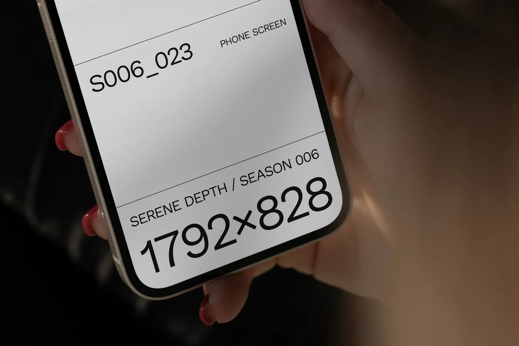 Close-up of a hand holding a phone with a mockup screen displaying 1792x828 resolution, focusing on screen details for design previews.