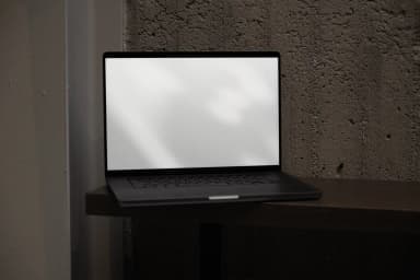 Blank laptop screen mockup on a wooden shelf, ready for design customization, with a realistic, textured background setting.