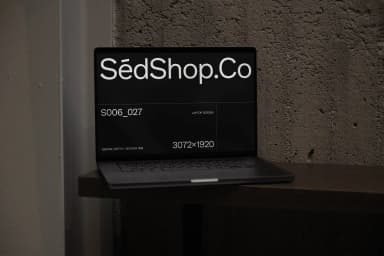 Close-up of a laptop screen mockup on a wooden shelf, displaying 'SédShop.Co' text, perfect for showcasing digital designs.