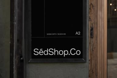 Close-up mockup of an A2 poster on an exterior wall displaying 'SédShop.Co' in a dark frame, highlighting the design details.