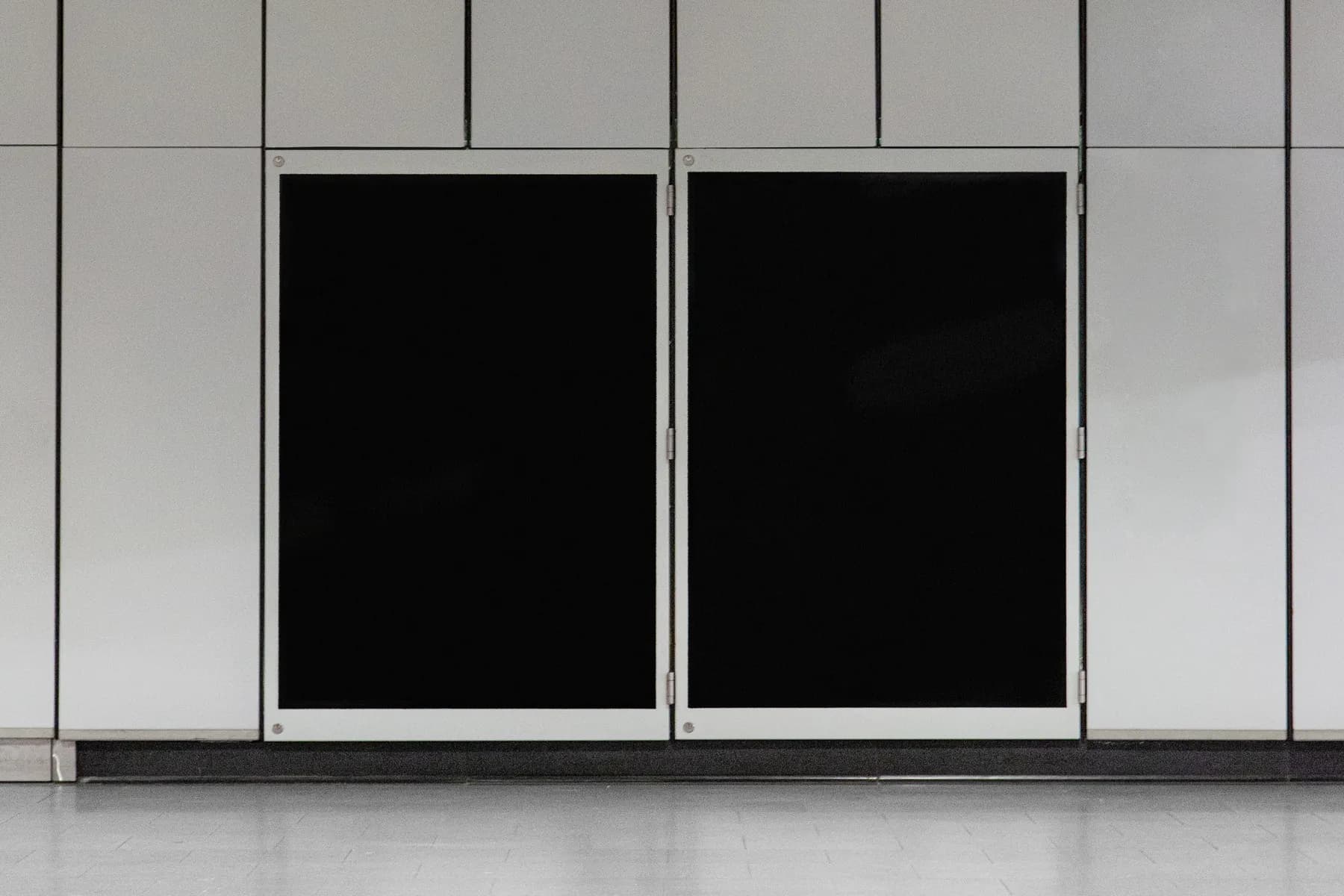Blank poster mockup with two empty black spaces on a tiled wall, ready for customization.