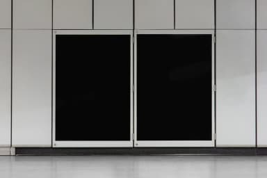 Blank poster mockup with two empty black spaces on a tiled wall, ready for customization.