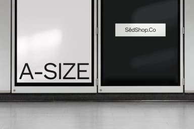Minimalist A-size poster mockup with one black and one white poster, on a tiled wall with floor reflections.